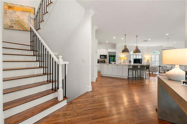 stairs with hardwood / wood-style flooring