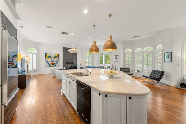 kitchen featuring black dishwasher, white cabinetry, a healthy amount of sunlight, and sink