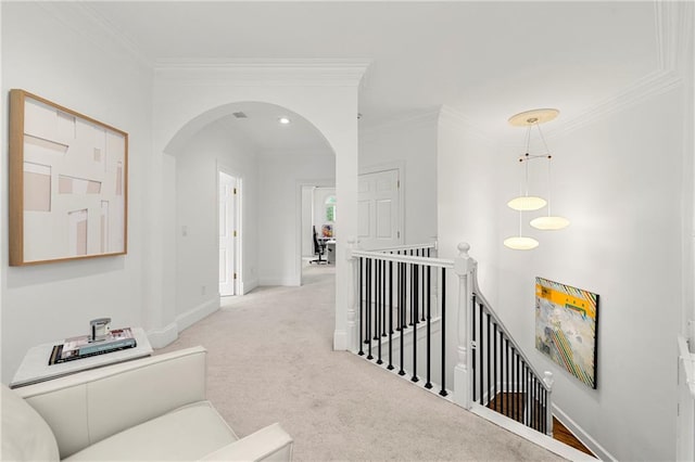 corridor featuring light colored carpet and ornamental molding