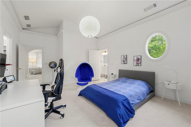 bedroom with ornamental molding, lofted ceiling, ensuite bath, and light colored carpet