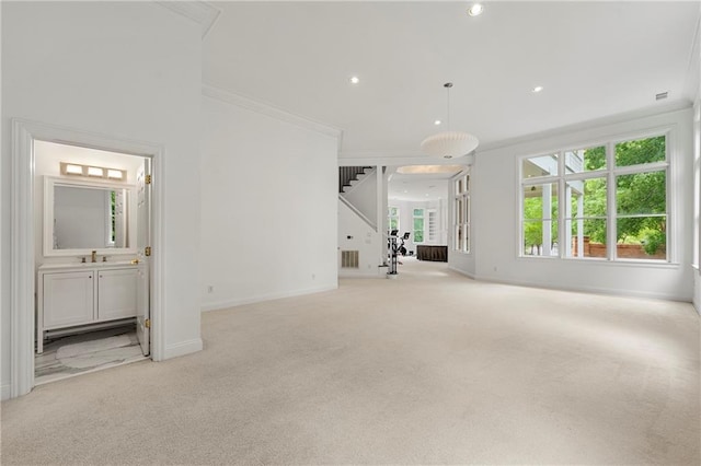 unfurnished living room with light colored carpet and ornamental molding