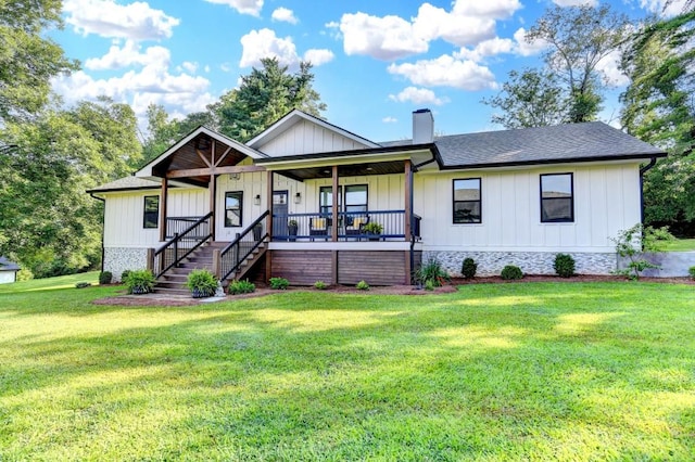 5441 E Main St, Flowery Branch, GA 30542 - view of front of home featuring a chimney, a porch, board and batten siding, a front lawn, and a shingled roof