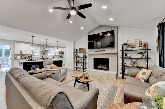 5441 E Main St, Flowery Branch, GA 30542 - living area featuring ceiling fan, recessed lighting, light wood-style flooring, lofted ceiling, and a fireplace