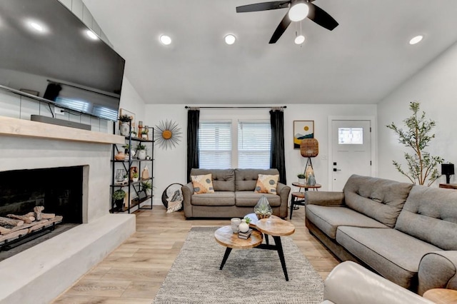 5441 E Main St, Flowery Branch, GA 30542 - living area with lofted ceiling, ceiling fan, wood finished floors, recessed lighting, and a fireplace with raised hearth