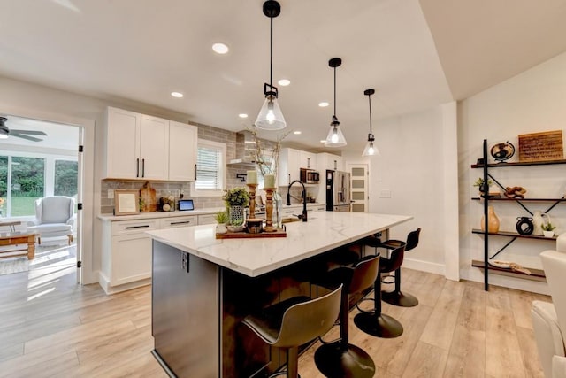 5441 E Main St, Flowery Branch, GA 30542 - kitchen featuring stainless steel appliances, plenty of natural light, white cabinetry, tasteful backsplash, and recessed lighting