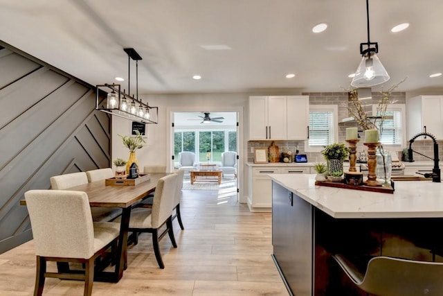 5441 E Main St, Flowery Branch, GA 30542 - kitchen featuring white cabinetry, light stone countertops, light wood-style floors, ceiling fan, and recessed lighting