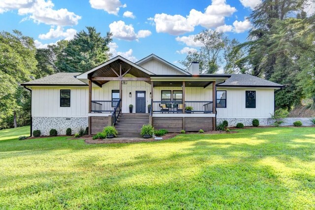 5441 E Main St, Flowery Branch, GA 30542 - view of front of house featuring covered porch, a front lawn, a chimney, stairway, and board and batten siding