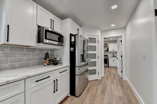 5441 E Main St, Flowery Branch, GA 30542 - kitchen featuring stainless steel appliances, white cabinetry, decorative backsplash, recessed lighting, and light wood-type flooring