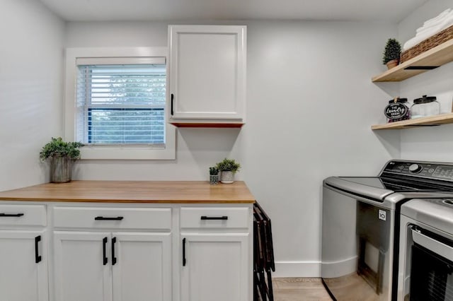 5441 E Main St, Flowery Branch, GA 30542 - washroom featuring washing machine and dryer and cabinet space
