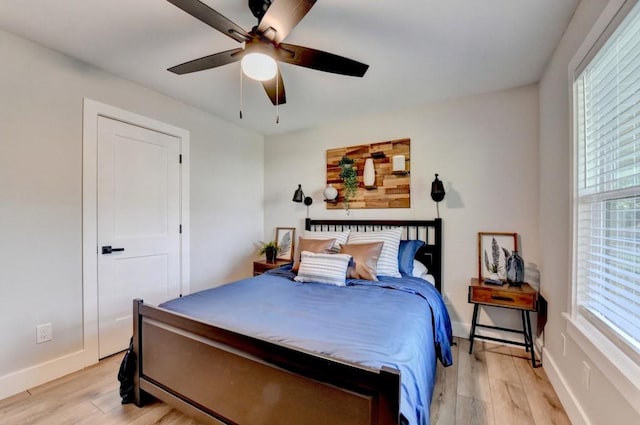 5441 E Main St, Flowery Branch, GA 30542 - bedroom featuring light wood finished floors, multiple windows, and ceiling fan