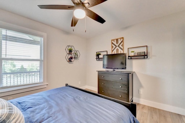 5441 E Main St, Flowery Branch, GA 30542 - bedroom with wood finished floors, multiple windows, and a ceiling fan
