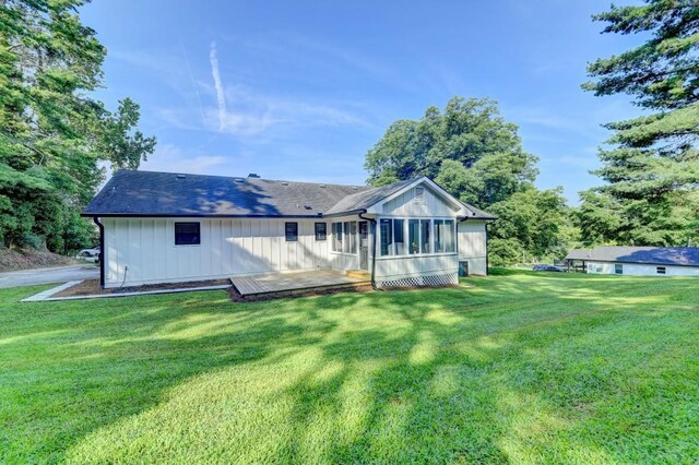 5441 E Main St, Flowery Branch, GA 30542 - rear view of property featuring a lawn, a sunroom, and board and batten siding
