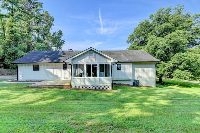 5441 E Main St, Flowery Branch, GA 30542 - rear view of house featuring a lawn, a sunroom, and board and batten siding