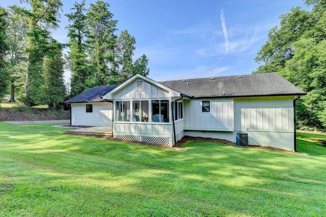 5441 E Main St, Flowery Branch, GA 30542 - rear view of property featuring a sunroom, roof with shingles, a yard, and board and batten siding
