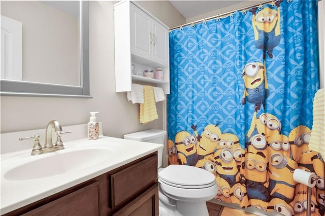 bathroom featuring toilet, vanity, tile patterned flooring, and a shower with curtain