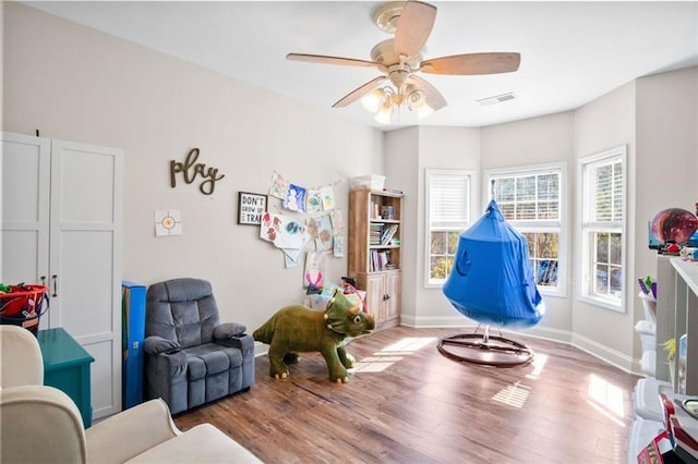 recreation room with ceiling fan and light hardwood / wood-style flooring