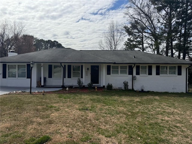 ranch-style home with a chimney, crawl space, covered porch, a front yard, and brick siding