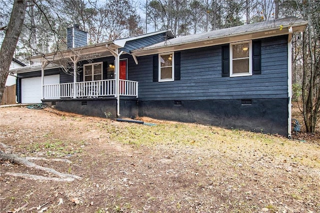 ranch-style house featuring covered porch and a garage