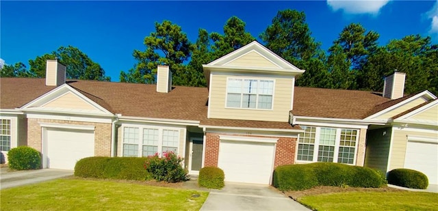 view of front of home with a front lawn and a garage