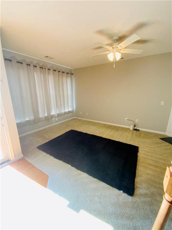 unfurnished room with carpet, ceiling fan, and plenty of natural light