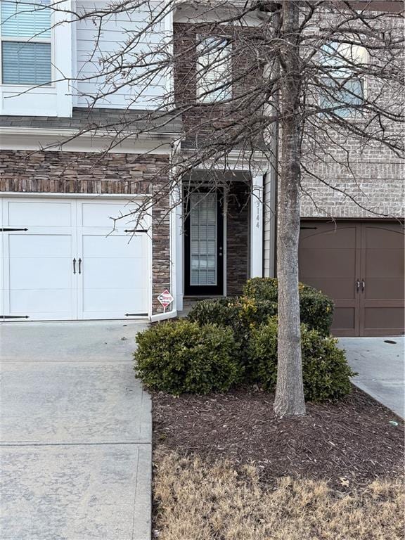 doorway to property with a garage