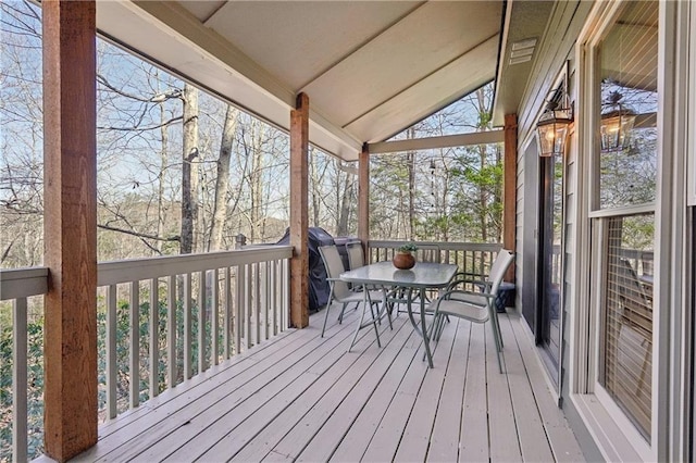 unfurnished sunroom with lofted ceiling