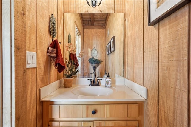 bathroom with vanity and wooden walls