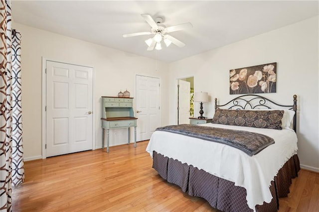 bedroom featuring light wood-style floors, ceiling fan, and baseboards