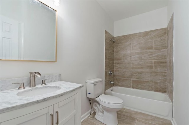 full bathroom with tiled shower / bath, vanity, and toilet