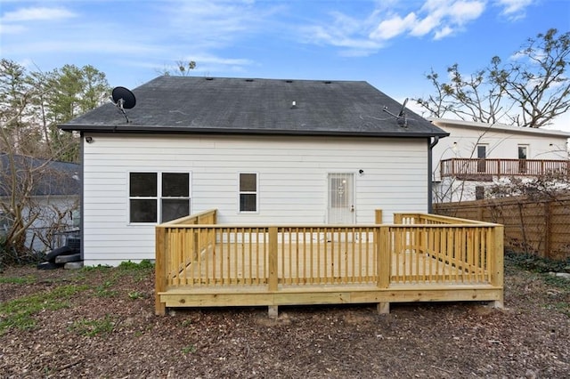 rear view of property with a wooden deck