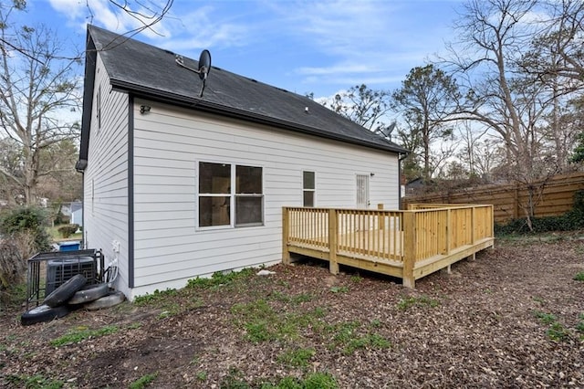 rear view of house with a wooden deck and central air condition unit