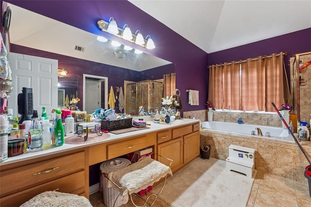 full bathroom with lofted ceiling, a bath, vanity, and tile patterned floors