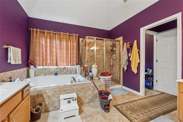 bathroom with vanity, a garden tub, a shower stall, and tile patterned flooring