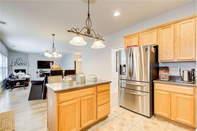 3258 Kessock Ridge Trl, Snellville, GA 30039 - kitchen featuring stainless steel fridge, light brown cabinetry, a kitchen island, hanging light fixtures, and open floor plan