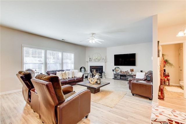 3258 Kessock Ridge Trl, Snellville, GA 30039 - living area with a ceiling fan, light wood-type flooring, and a glass covered fireplace