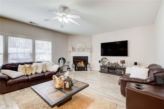 3258 Kessock Ridge Trl, Snellville, GA 30039 - living area with a ceiling fan, a lit fireplace, and wood finished floors