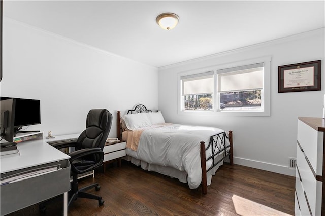 bedroom featuring baseboards, dark wood-style floors, and crown molding