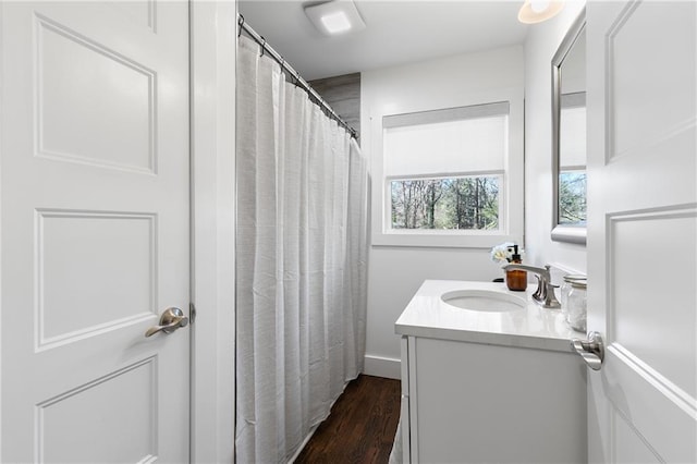 bathroom featuring vanity, a shower with shower curtain, and wood finished floors