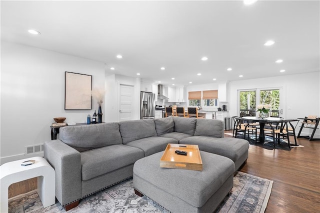 living area featuring visible vents, recessed lighting, and wood finished floors