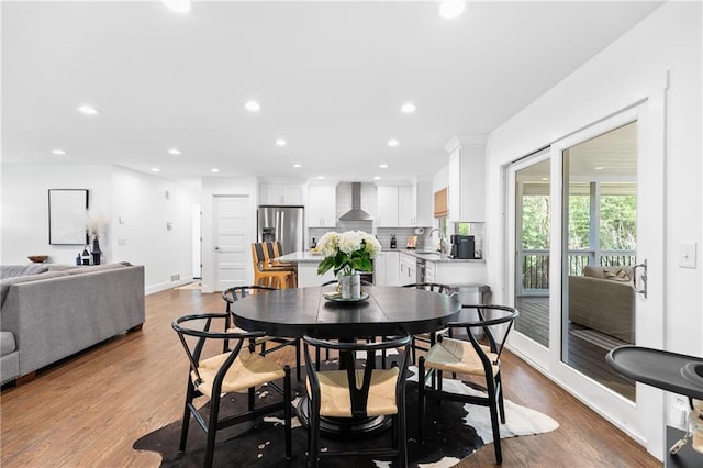 dining room featuring recessed lighting, baseboards, and wood finished floors