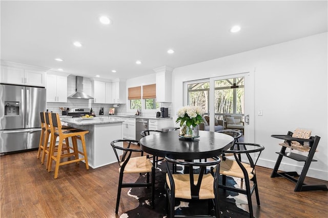 dining area with recessed lighting, baseboards, and dark wood-style flooring