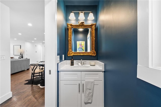 bathroom featuring vanity, recessed lighting, and wood finished floors