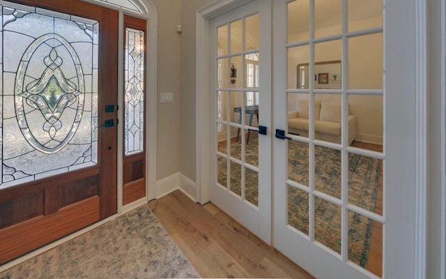 foyer entrance with french doors and hardwood / wood-style floors