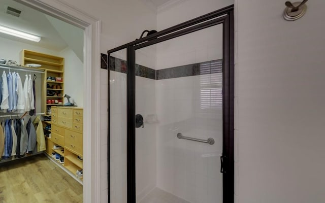 bathroom featuring walk in shower and hardwood / wood-style flooring