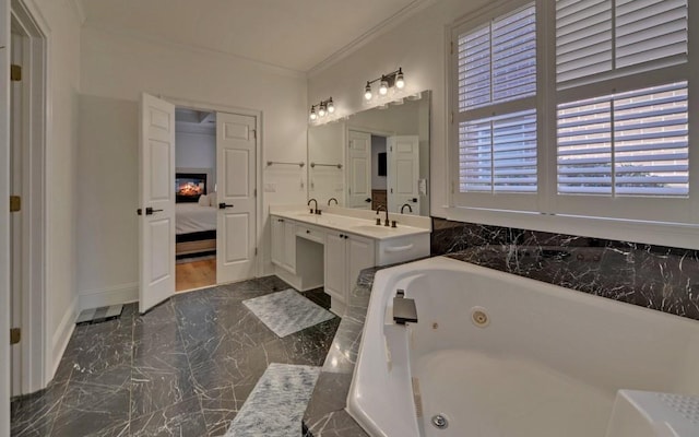 bathroom with tiled tub, vanity, and ornamental molding