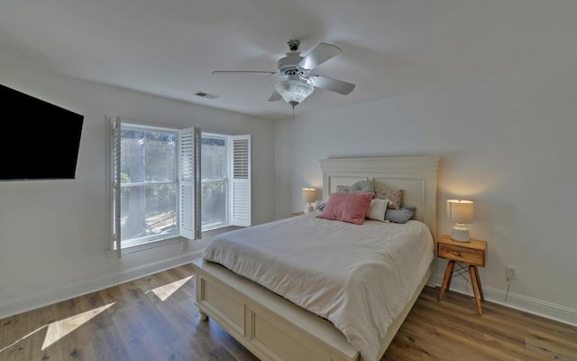 bedroom with ceiling fan and wood-type flooring