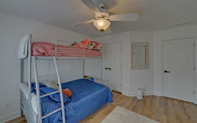 bedroom with ceiling fan and light wood-type flooring