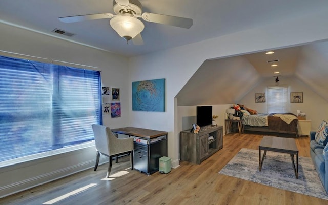 interior space featuring ceiling fan, light wood-type flooring, and vaulted ceiling