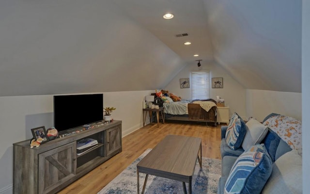 bedroom with light hardwood / wood-style flooring and lofted ceiling