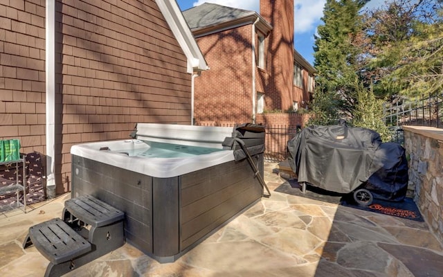 view of patio / terrace with a hot tub and area for grilling